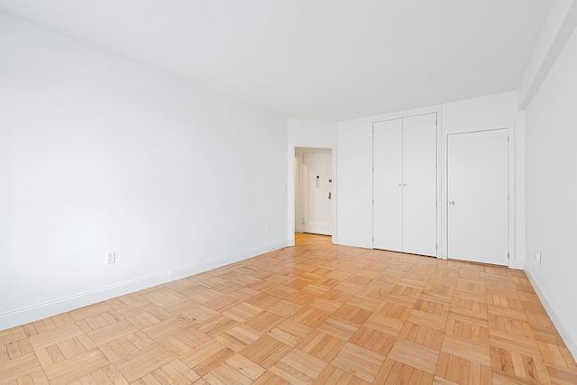 unfurnished bedroom with baseboards and a closet