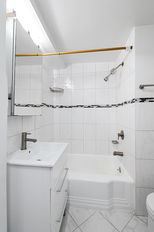 full bathroom with toilet, marble finish floor, shower / tub combination, and tile walls