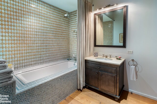 10 E 22nd St Unit 3, New York City, NY 10010 - full bath featuring wood finished floors, tiled shower / bath, and vanity