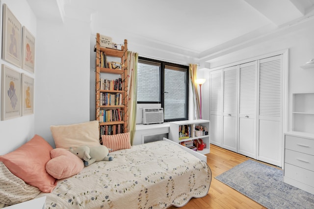 227 E 57th St Unit 9Fg, New York City, NY 10022 - bedroom featuring a view of city, ornamental molding, and wood finished floors