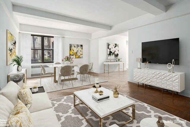 living room with radiator heating unit, baseboards, and beamed ceiling