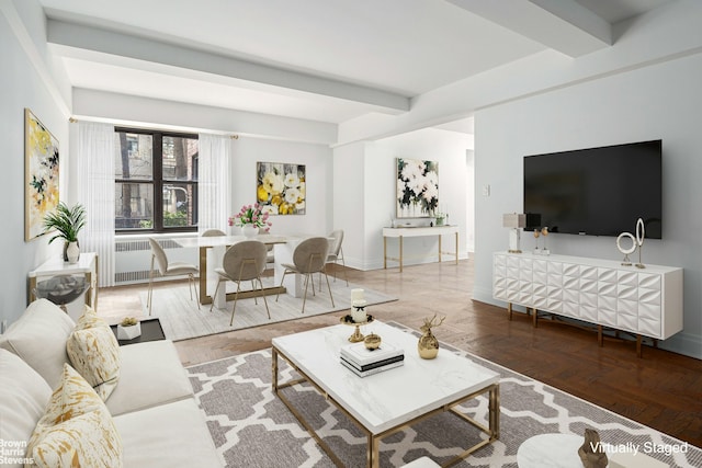 living room with beamed ceiling, baseboards, and radiator