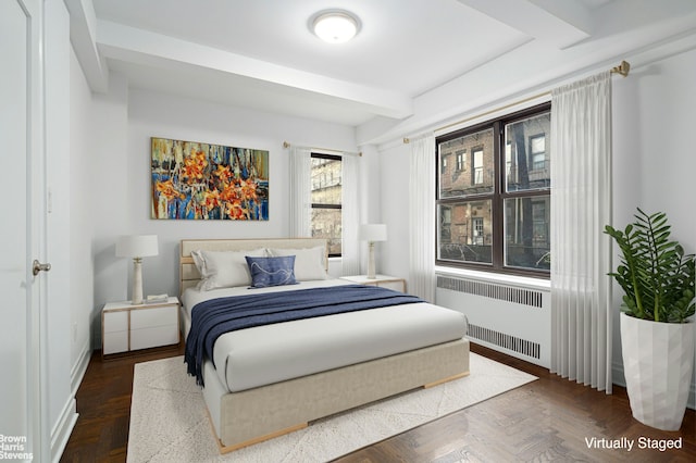 bedroom with baseboards, beamed ceiling, and radiator