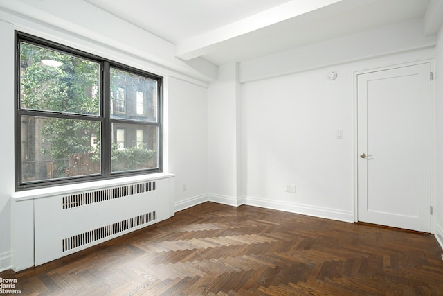 unfurnished room with beamed ceiling, radiator heating unit, and baseboards