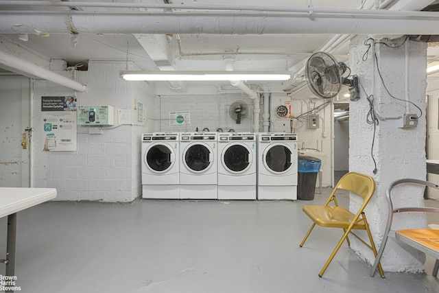 community laundry room with washer and clothes dryer