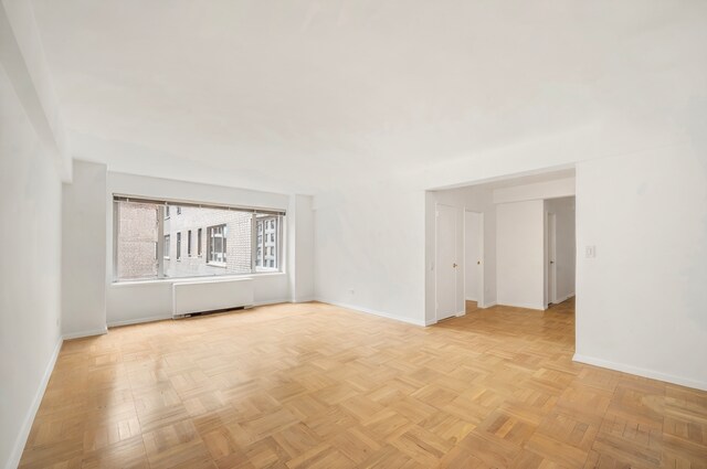 200 E 57th St Unit 9G, New York City, NY 10022 - empty room featuring baseboards and radiator