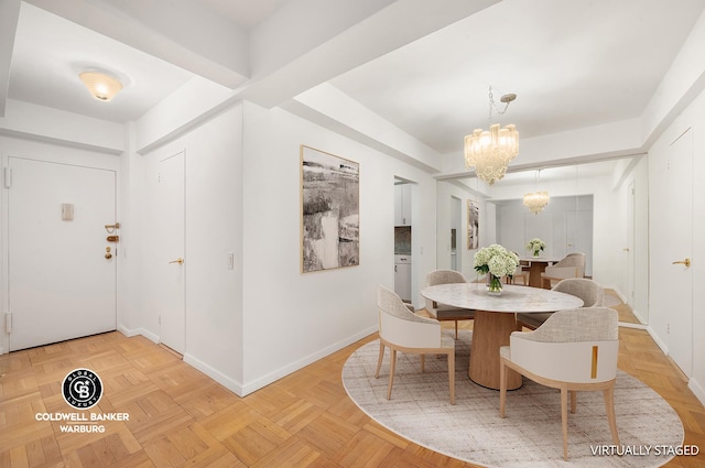 dining space featuring baseboards and an inviting chandelier