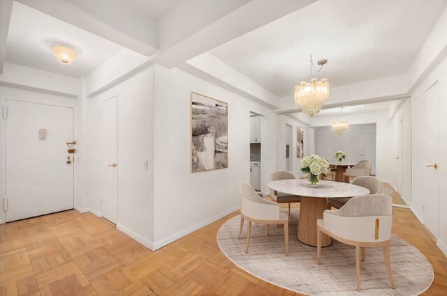 200 E 57th St Unit 9G, New York City, NY 10022 - dining space with a chandelier and baseboards