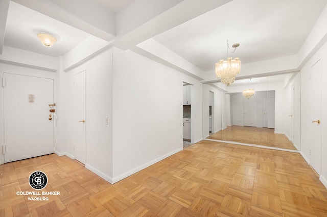 200 E 57th St Unit 9G, New York City, NY 10022 - entrance foyer featuring a chandelier and baseboards