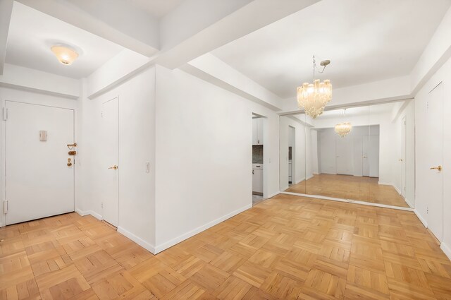 200 E 57th St Unit 9G, New York City, NY 10022 - foyer featuring a chandelier and baseboards
