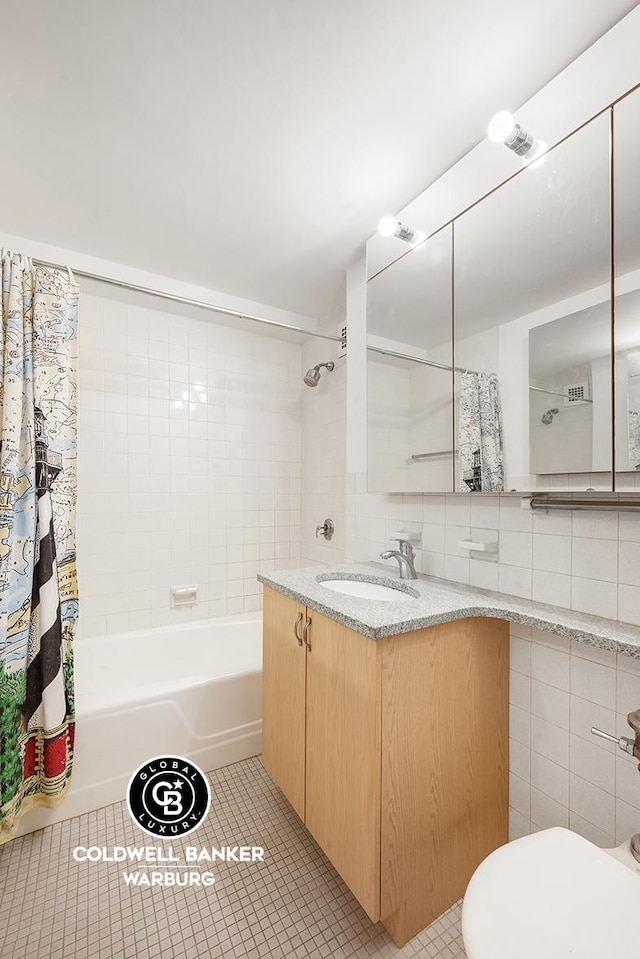 200 E 57th St Unit 9G, New York City, NY 10022 - full bath with shower / bathtub combination with curtain, vanity, tile patterned flooring, and tile walls