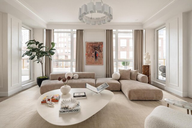 living area with a healthy amount of sunlight and crown molding