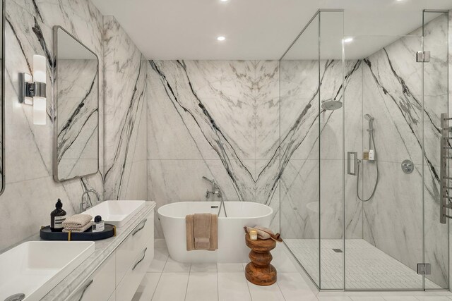 126 E 86th St Unit 17A, New York City, NY 10028 - full bathroom featuring vanity, a marble finish shower, recessed lighting, a freestanding bath, and tile walls