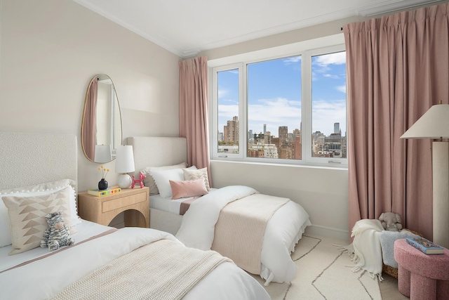 carpeted bedroom with ornamental molding, a view of city, and baseboards