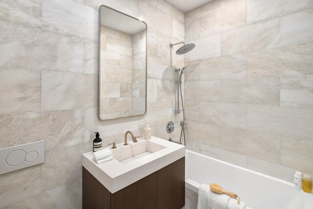 126 E 86th St Unit 17A, New York City, NY 10028 - bathroom with vanity, tile walls, and tiled shower / bath