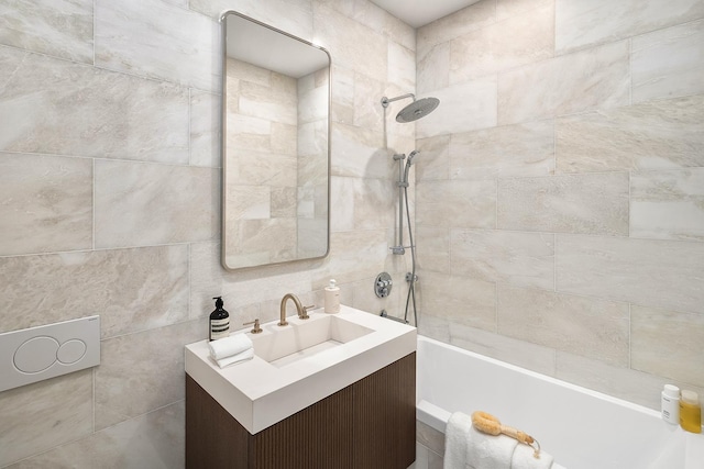 full bath with tiled shower / bath, vanity, and tile walls