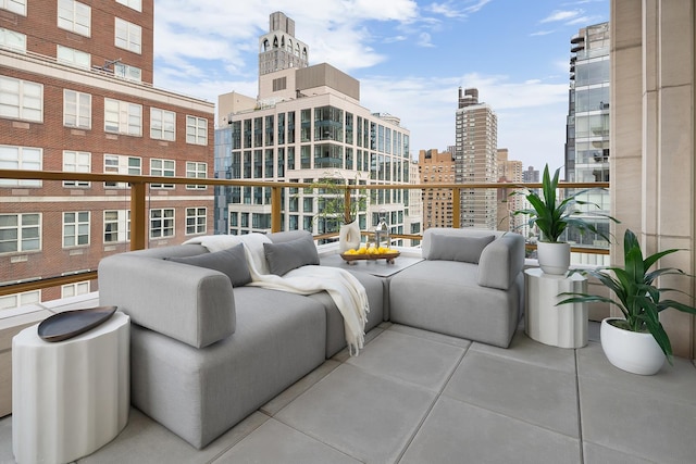 balcony with outdoor lounge area and a city view