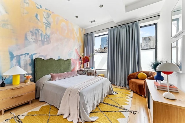 bedroom featuring visible vents and light wood-style flooring