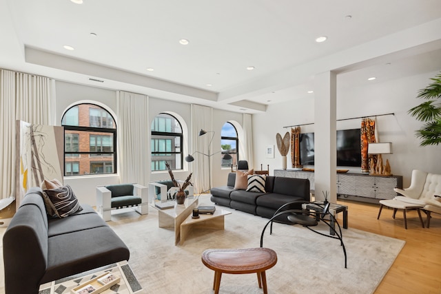 living room featuring recessed lighting, visible vents, and light wood-style flooring