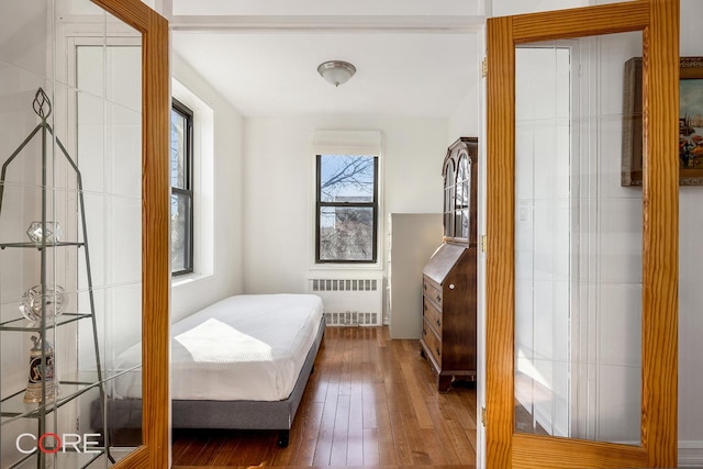 bedroom featuring dark wood-type flooring and radiator