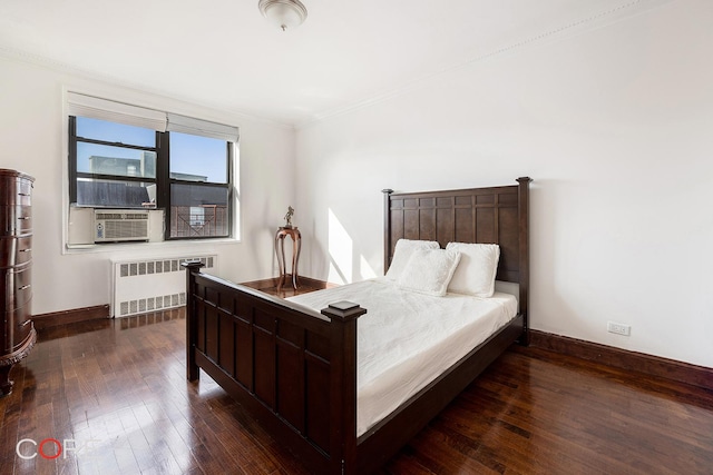 bedroom featuring radiator, dark wood-style floors, baseboards, and ornamental molding