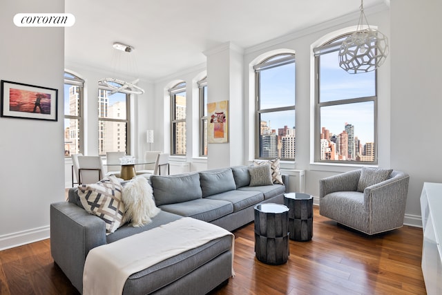 living area with baseboards, dark wood-style floors, a city view, crown molding, and a notable chandelier