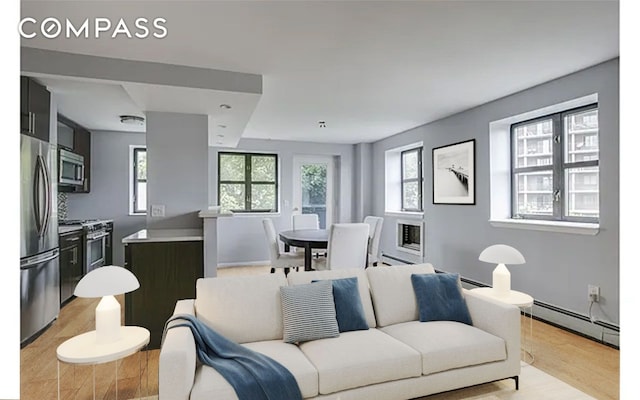 living room featuring light wood-style floors and baseboard heating