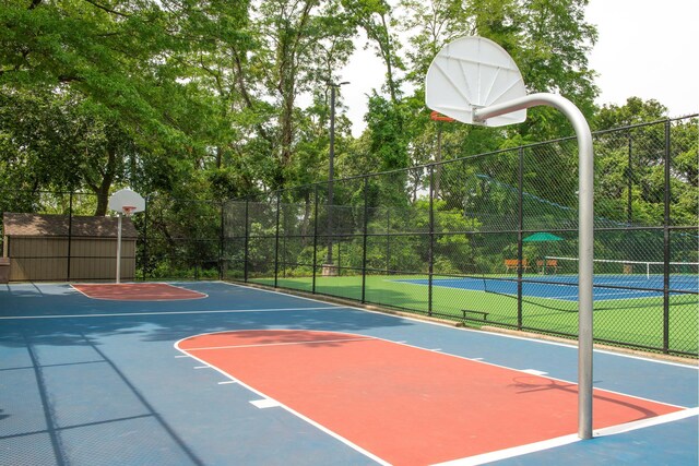 view of sport court featuring community basketball court and fence