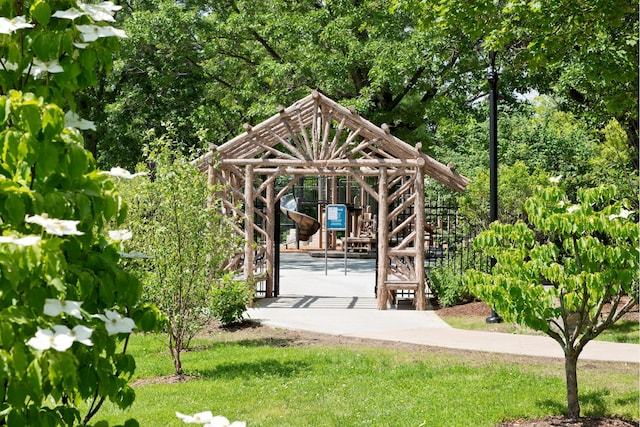 view of community featuring a playground and a lawn