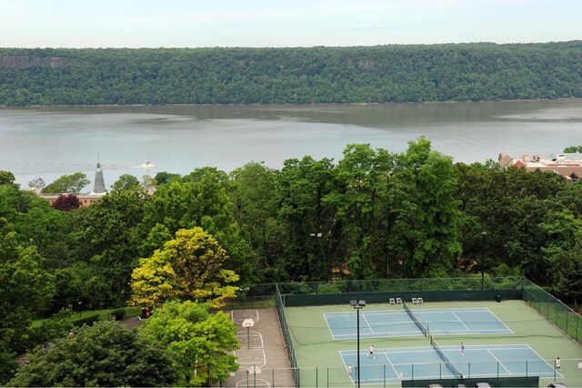 water view with fence and a wooded view