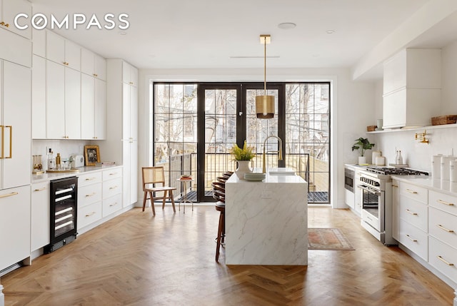 kitchen with beverage cooler, modern cabinets, and premium appliances