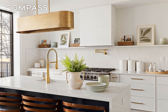 kitchen with white cabinets, plenty of natural light, open shelves, and backsplash