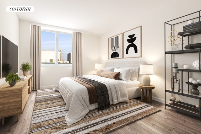 bedroom with wood finished floors and baseboards