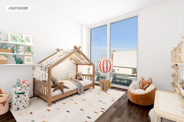 bedroom with wood finished floors, expansive windows, and multiple windows