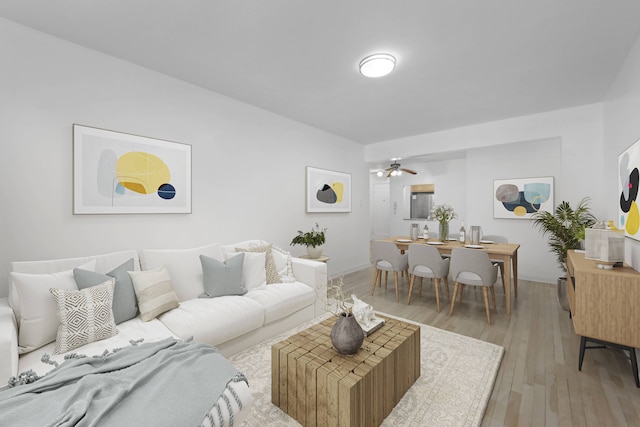 living room with light wood-style flooring and a ceiling fan