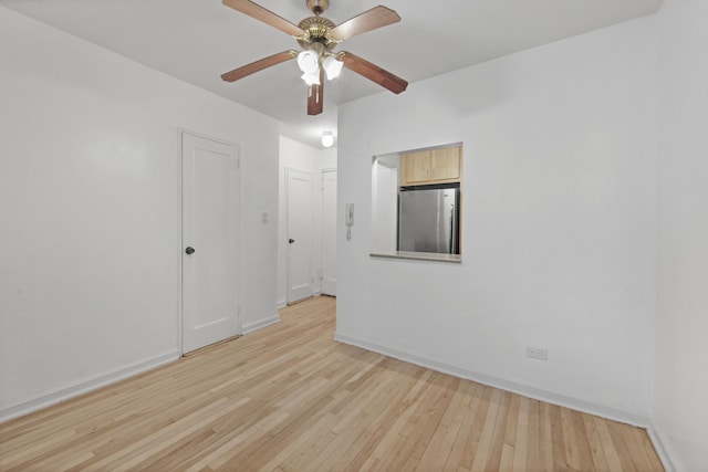 34-40 78th St Unit 4H, New York City, NY 11372 - spare room featuring light wood-style flooring, baseboards, and ceiling fan