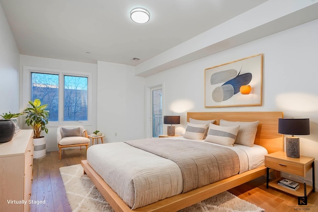 bedroom featuring light wood finished floors and visible vents