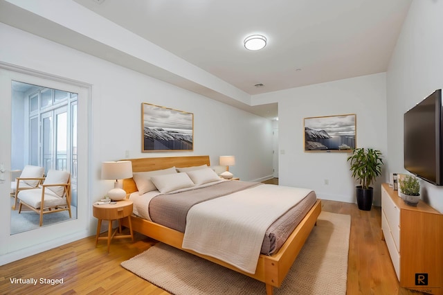 bedroom featuring baseboards and light wood-style floors