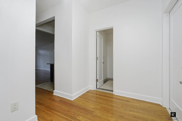 interior space featuring light wood-style floors and baseboards