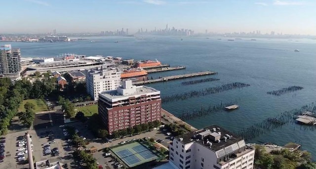 drone / aerial view featuring a view of city and a water view
