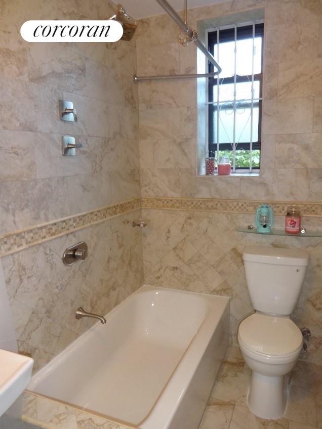 bathroom with toilet and shower / tub combination