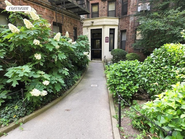 view of exterior entry featuring brick siding