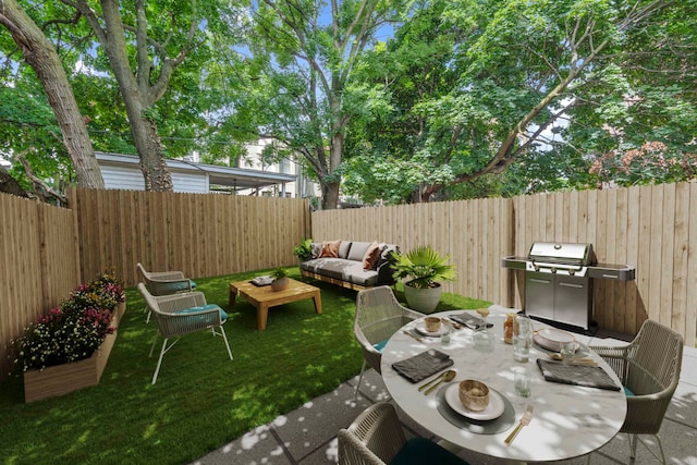view of patio / terrace featuring grilling area, a fenced backyard, and an outdoor hangout area