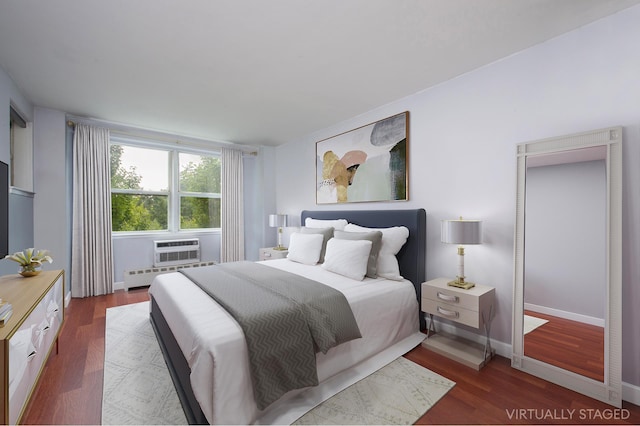 5900 Arlington Ave Unit 2S, New York City, NY 10471 - bedroom with baseboards, a wall mounted air conditioner, and dark wood-type flooring