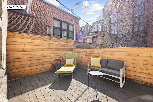 deck featuring fence and an outdoor living space