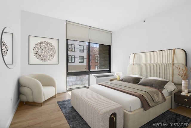 bedroom featuring light wood-style flooring and baseboards