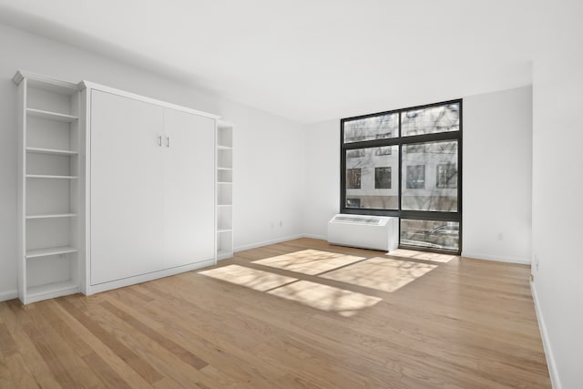 unfurnished bedroom featuring light wood-type flooring and baseboards