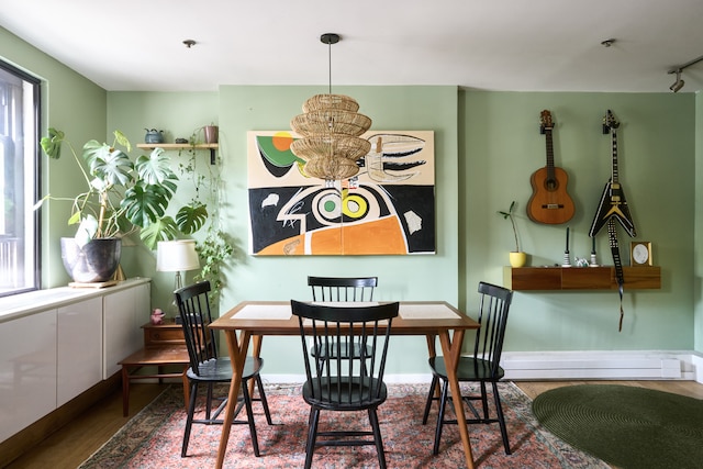 400 E 14th St Unit 2A, New York City, NY 10009 - dining room with an inviting chandelier, a wealth of natural light, and wood finished floors
