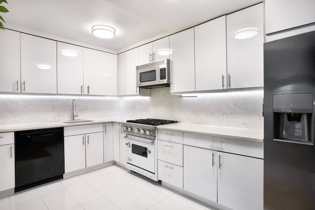 kitchen with a sink, white cabinetry, stainless steel appliances, and light countertops