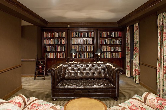 living area with baseboards, carpet, and crown molding